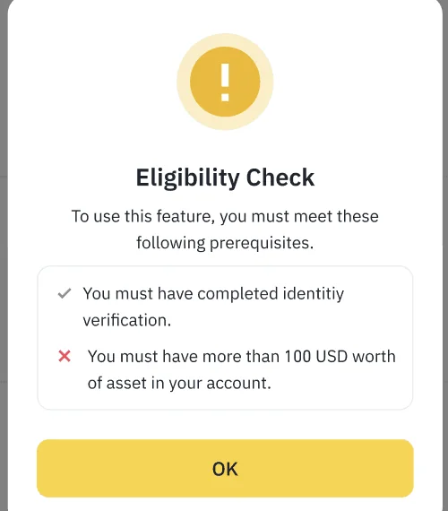 幣安資格檢查彈窗,列出兩項條件:已完成身分驗證(打勾)、帳戶資產須超過 100 美元(打叉),下方為 OK 按鈕